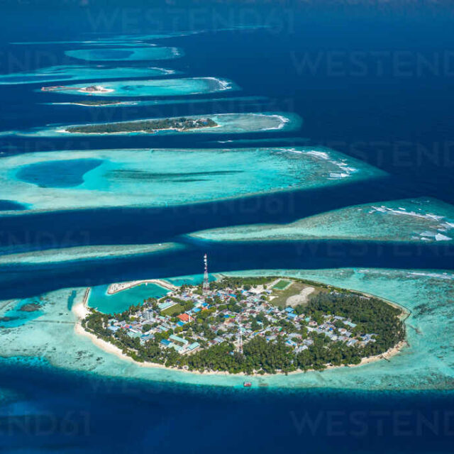 Aerial view of local, inhabited island Felidhoo, located in Vaavu Atoll, Maldives, Indian Ocean and the neigbor island Thinadhoo in the distance